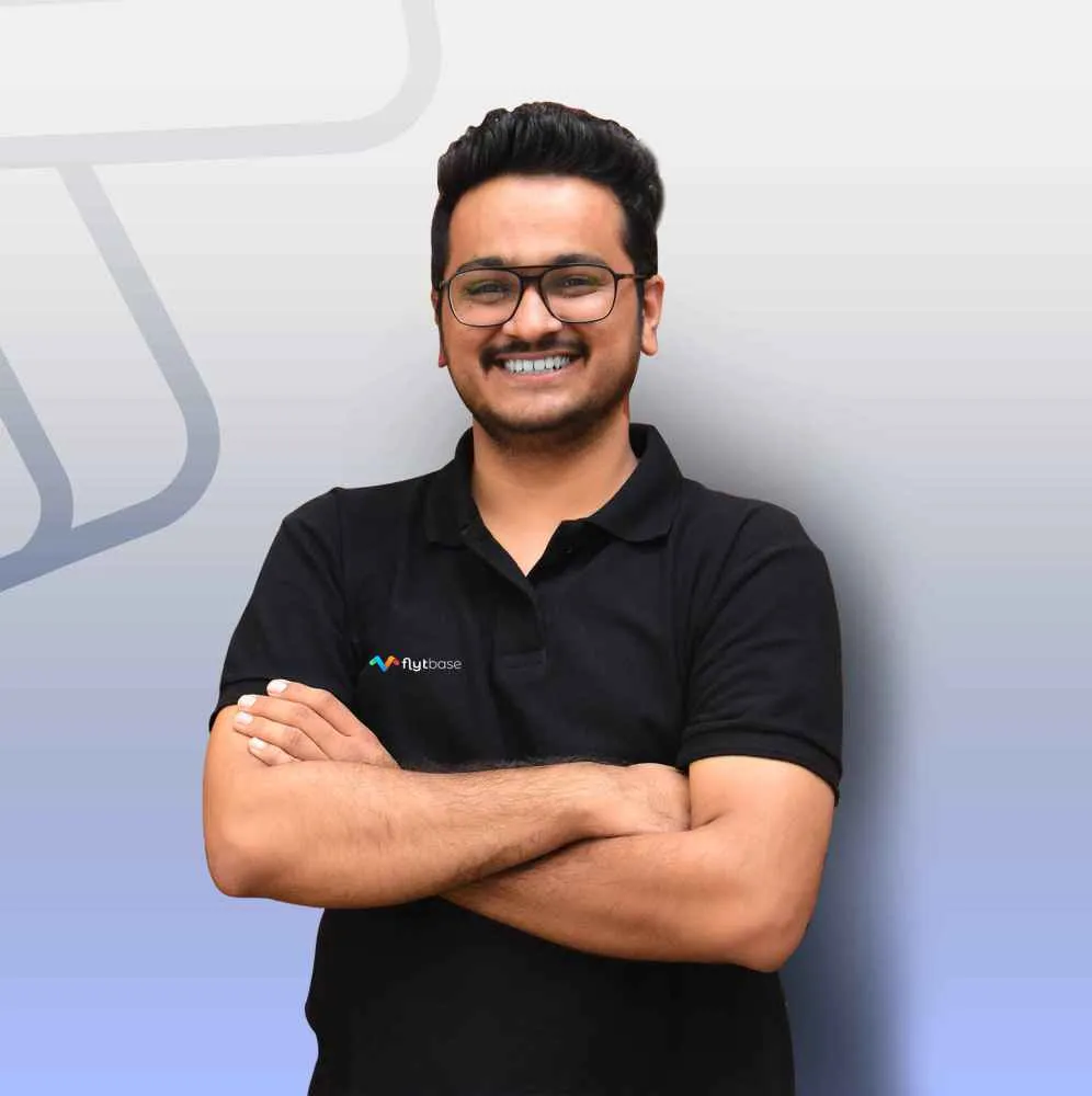 Achal Negi, Director of BD at FlytBase, in a black polo with arms crossed.