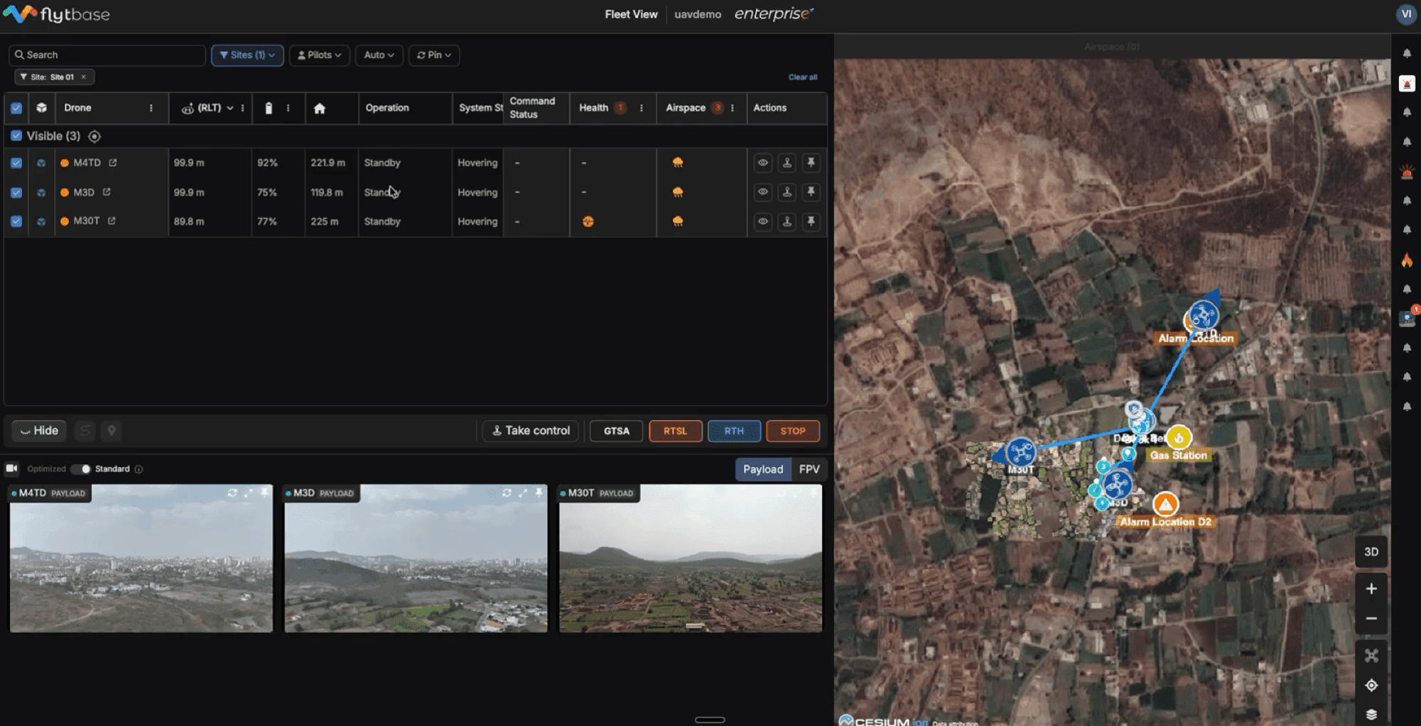 FlytBase Fleet View — multi-drone live telemetry table, video feeds, and Cesium map showing alarm locations