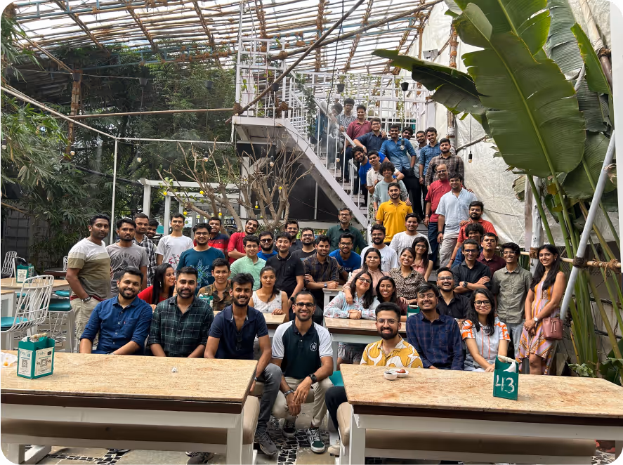 Large group of FlytBase team members posing outdoors.