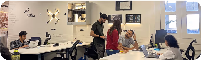 People working with drones inside the FlytBase office.