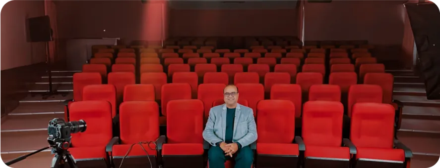 Founder seated alone in an empty movie theater during an offsite.